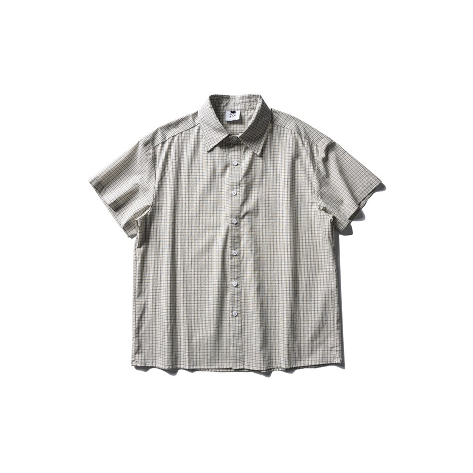 Flat-lay front of a short-sleeve button-up shirt in a light cream small grid check with a pointed collar