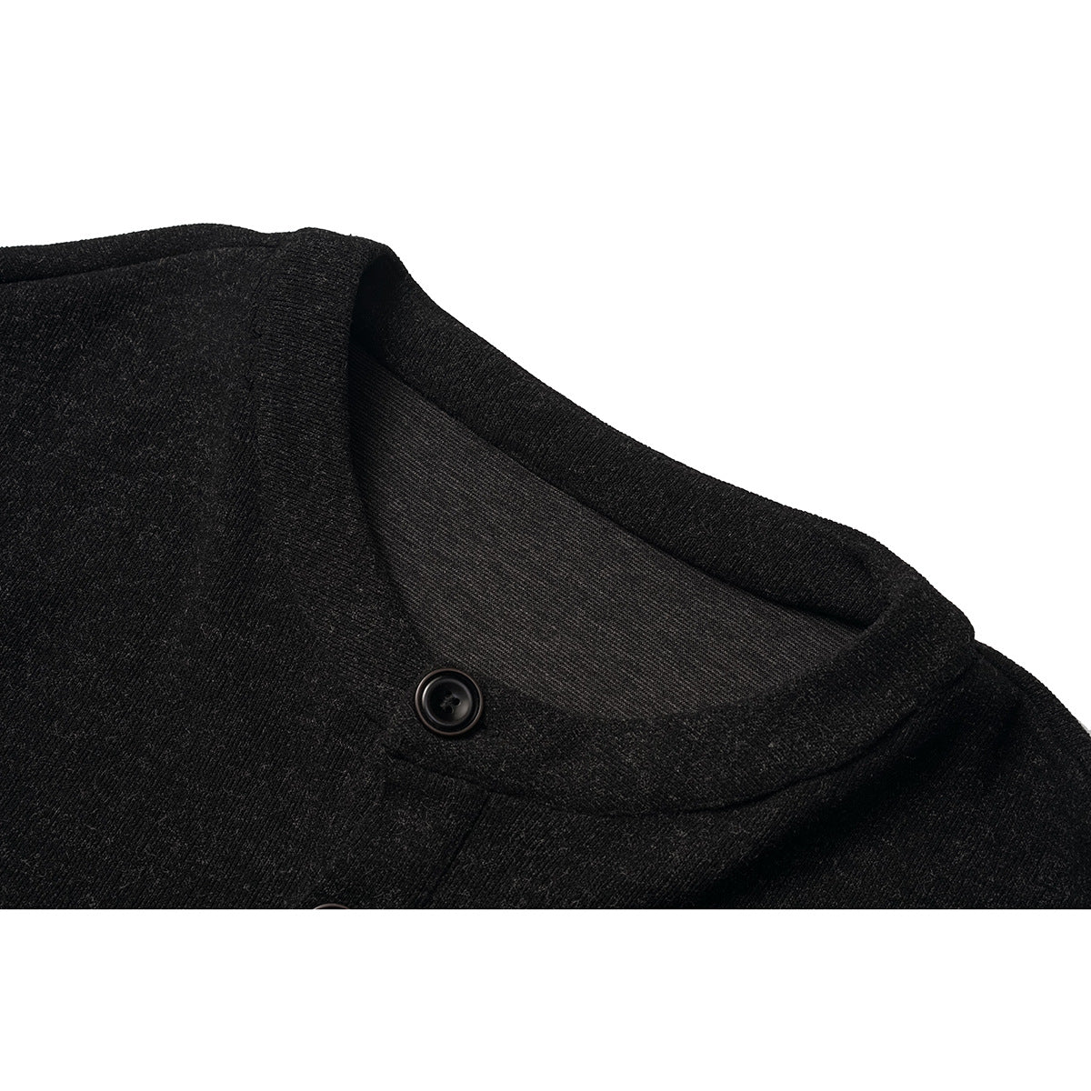 Close-up of a black knit cardigan's rounded neckline and button.