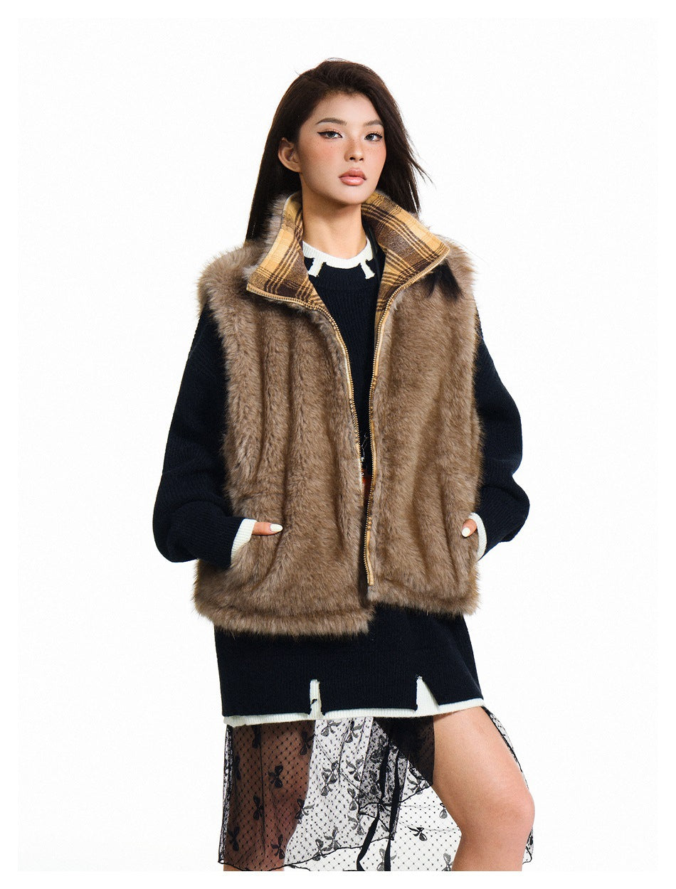 Model wearing a brown fur-textured zip vest with a plaid collar over a dark sweater.