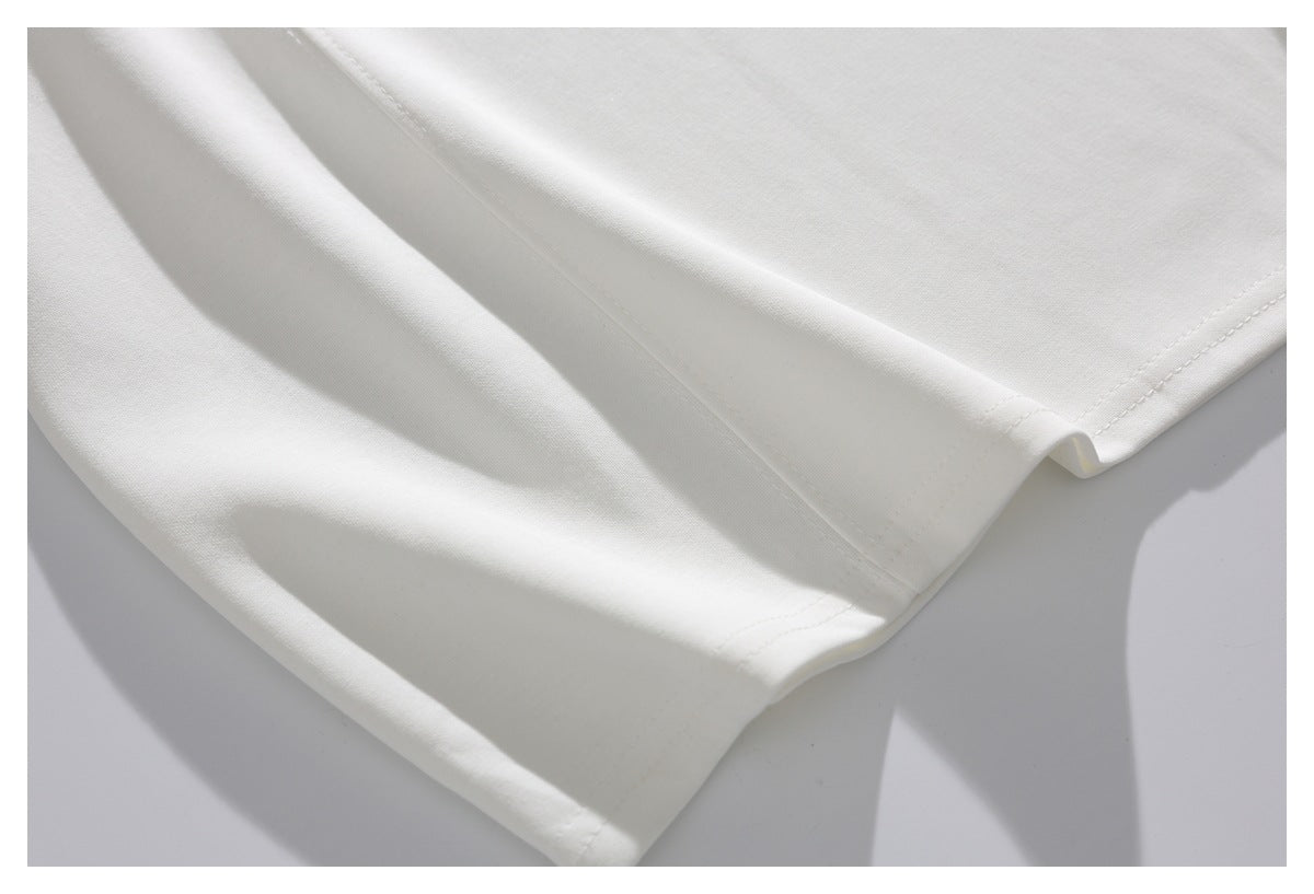 Close-up of a white garment hem with visible double stitching.