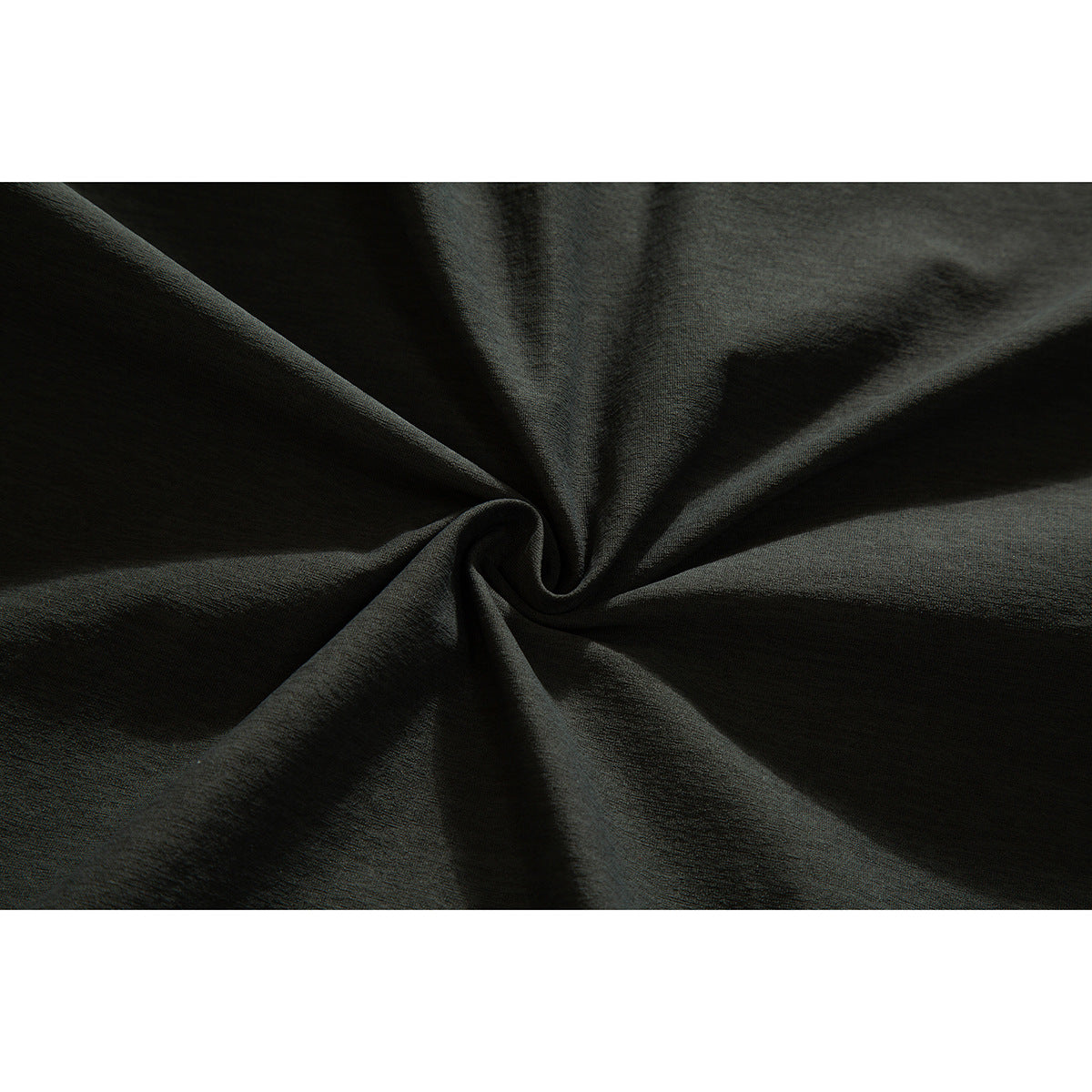 Close-up of dark charcoal fabric gathered into soft folds.