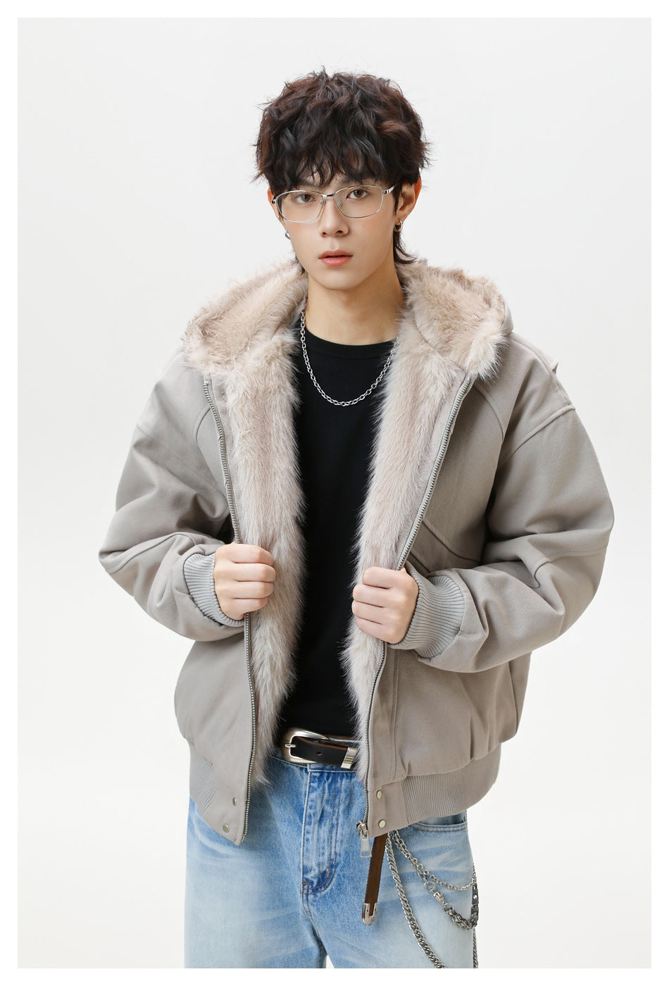 Model presents the open light gray jacket, showing its plush hood lining, front zipper, and ribbed cuffs.