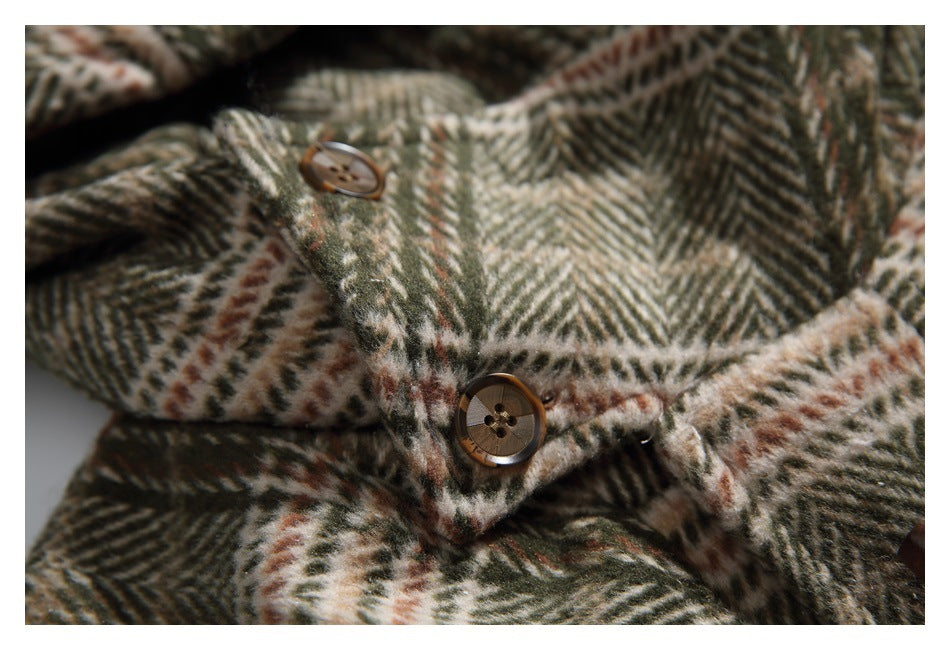 Close-up of brown buttons and the olive, cream, and rust plaid coat fabric.