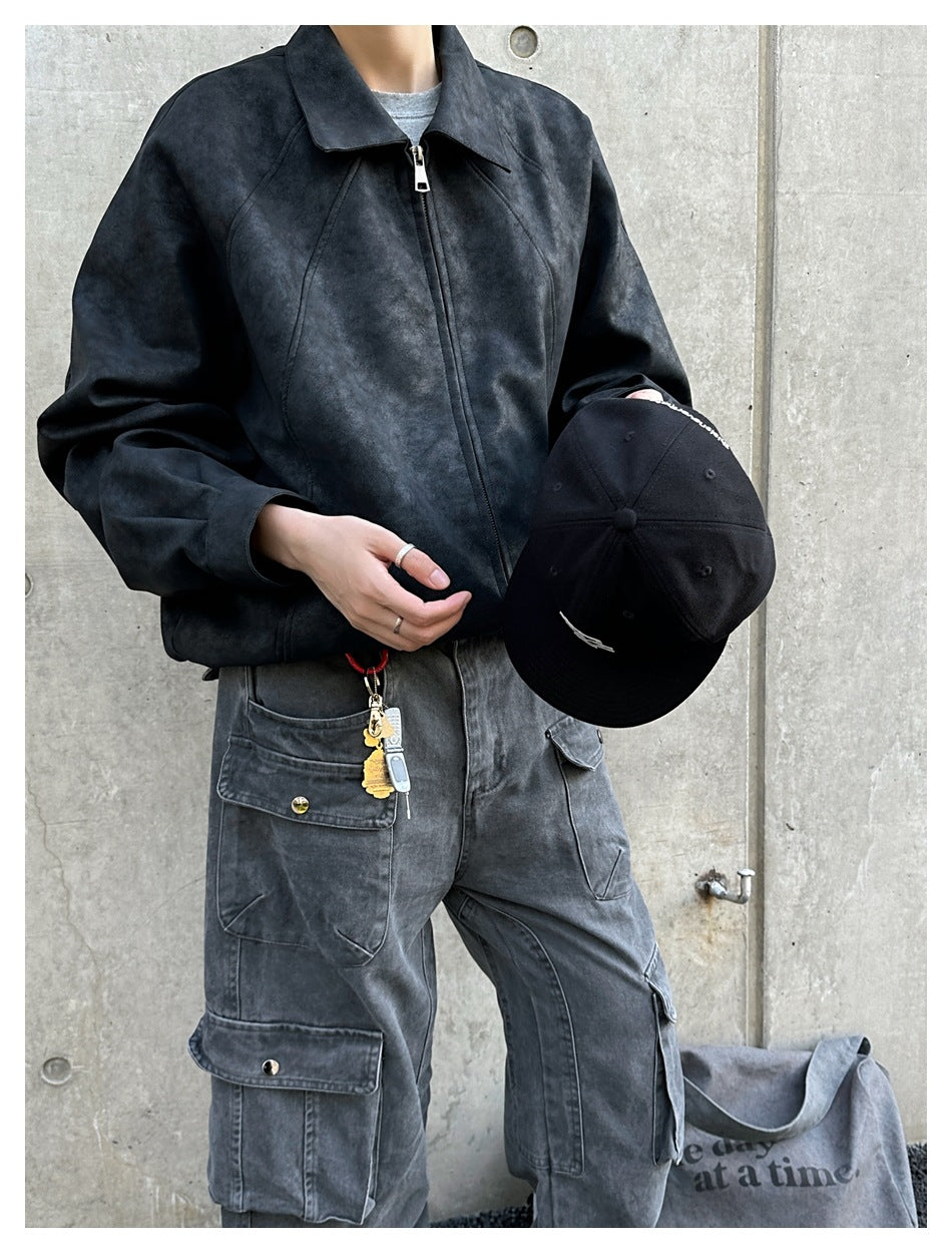 Closer front view of a person wearing a charcoal zip-front jacket with a wide collar and gray cargo pants.