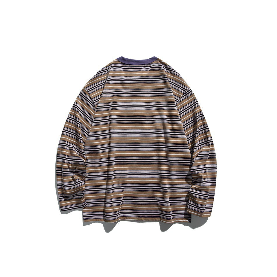 Back view of a tan, navy, and white striped long-sleeve shirt with a purple crew neckline.