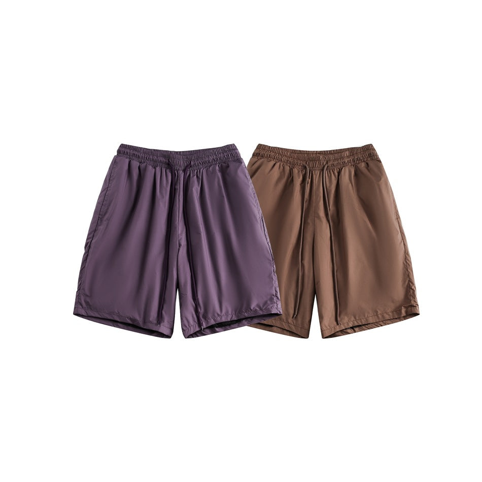Two pairs of loose, elastic-waist shorts shown together in purple and brown.
