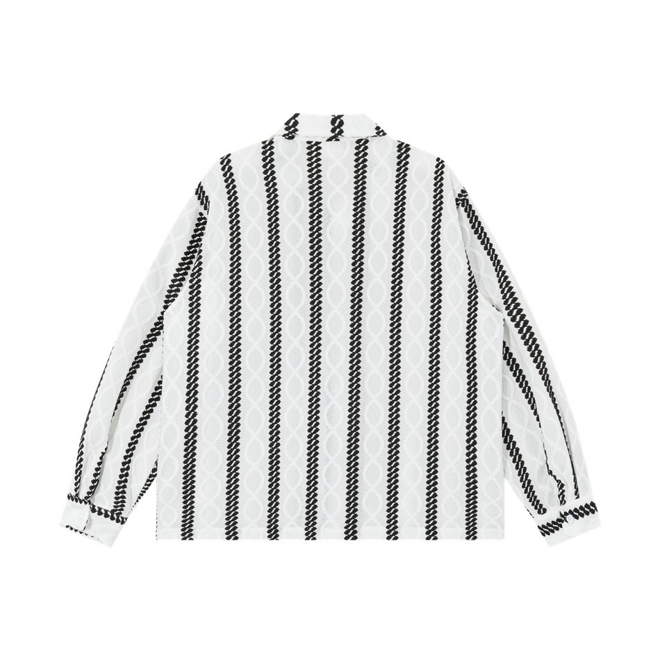 Back view of a white long-sleeve collared shirt with vertical black braided stripes and pale textured motifs.