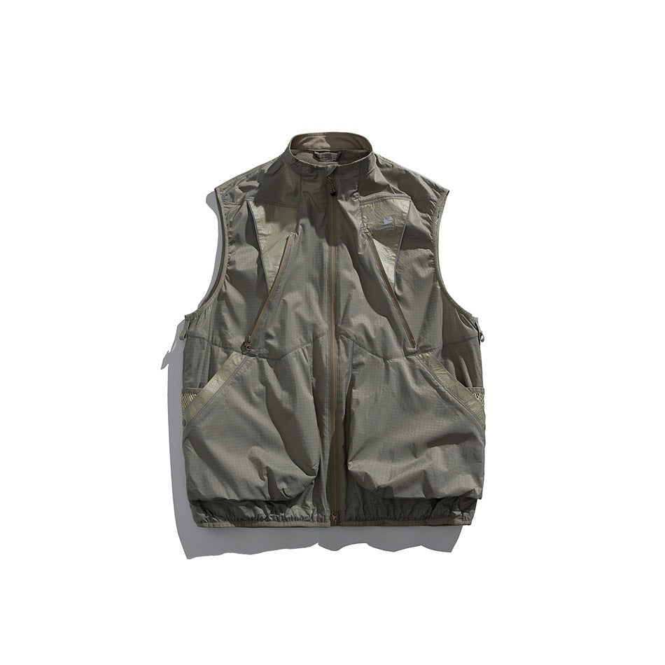 Front view of an olive-gray sleeveless utility vest with a stand collar, zip front and large pockets.
