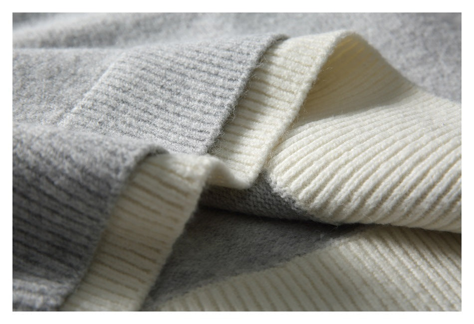 Close-up of gray and cream knit garment edges with contrasting ribbed trim.