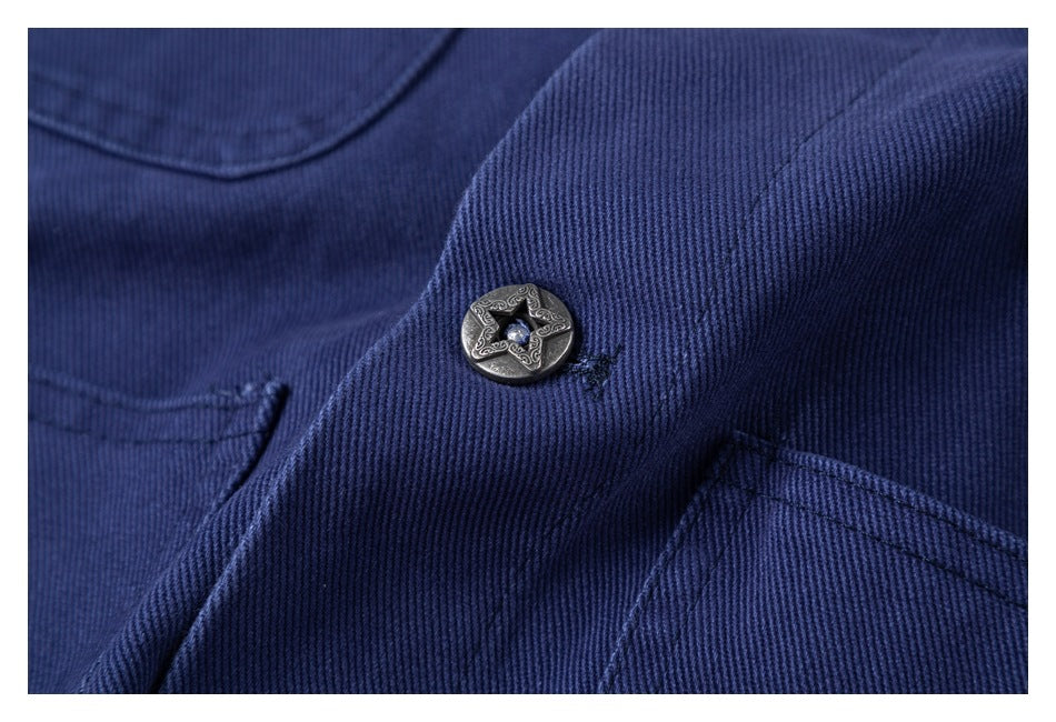Close-up of a decorative star-pattern button on the navy jacket, showing the ribbed fabric and stitching.