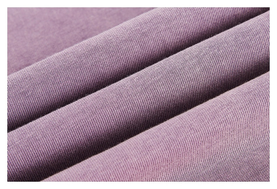 Close-up of mauve-purple fabric showing a fine, closely knit texture and soft folds.