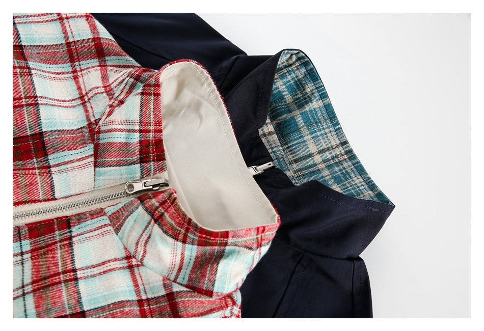 Close-up of overlapping jackets showing a plaid collar lining, a front zipper, and contrasting navy fabric.