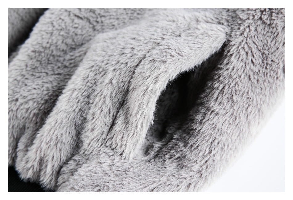 Close-up of a slit pocket opening edged with gray and white shaggy fabric.