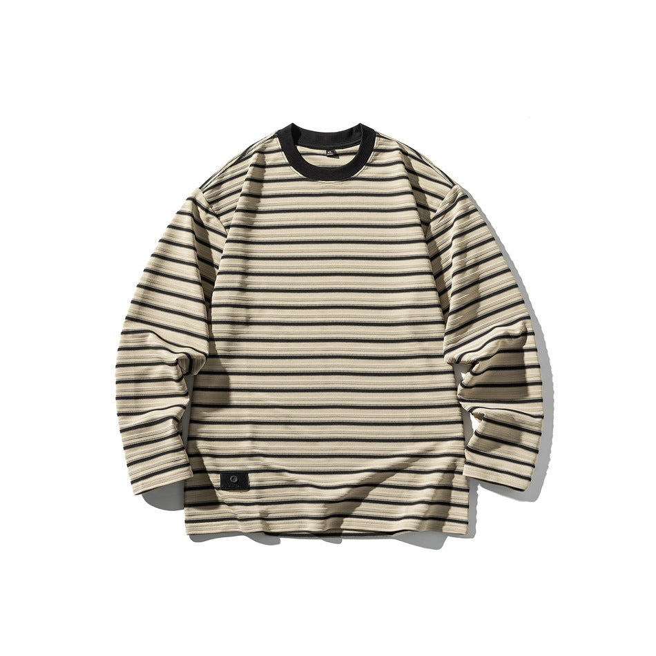 Khaki long-sleeve crew-neck top with black horizontal stripes, black collar and small patch at lower hem