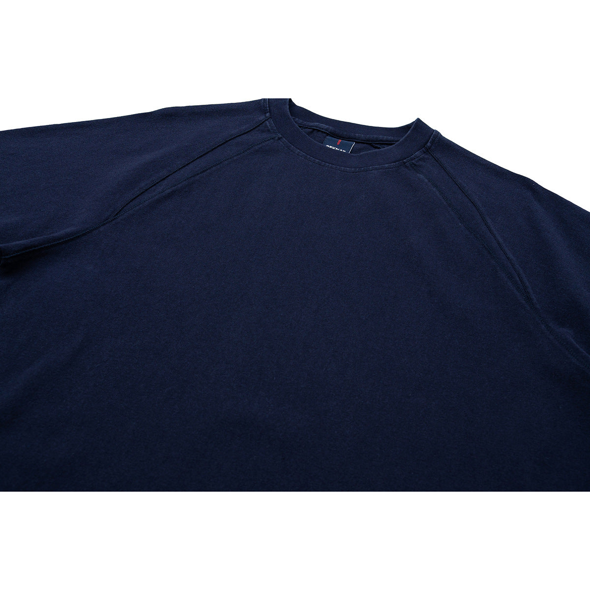 Close-up of a dark navy short-sleeve shirt showing its crew neck and raglan shoulder seams.
