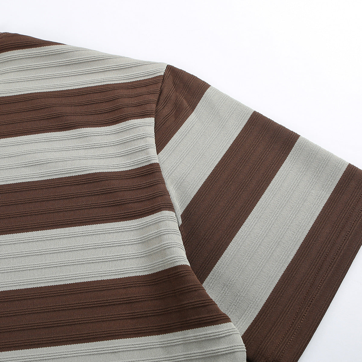 Close-up of the T-shirt's short sleeve and textured brown and gray stripes.