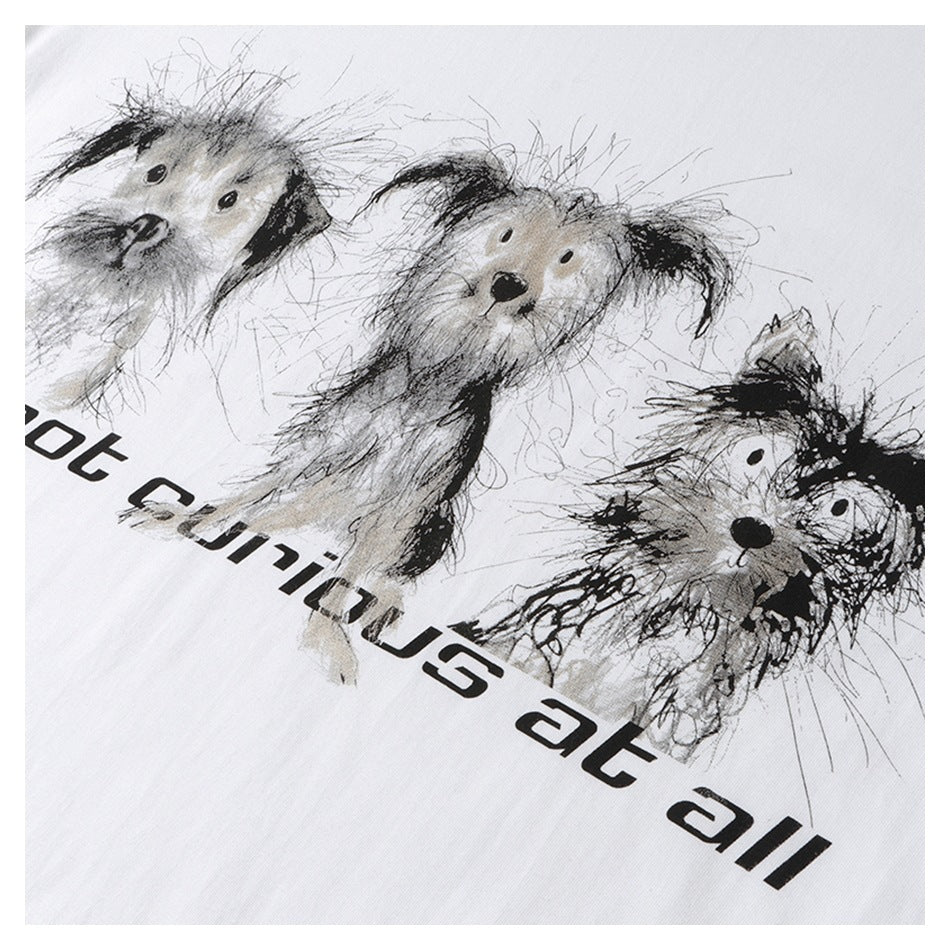 Close-up of three sketch-style dogs and black lettering printed on a white T-shirt, framed by a white border.