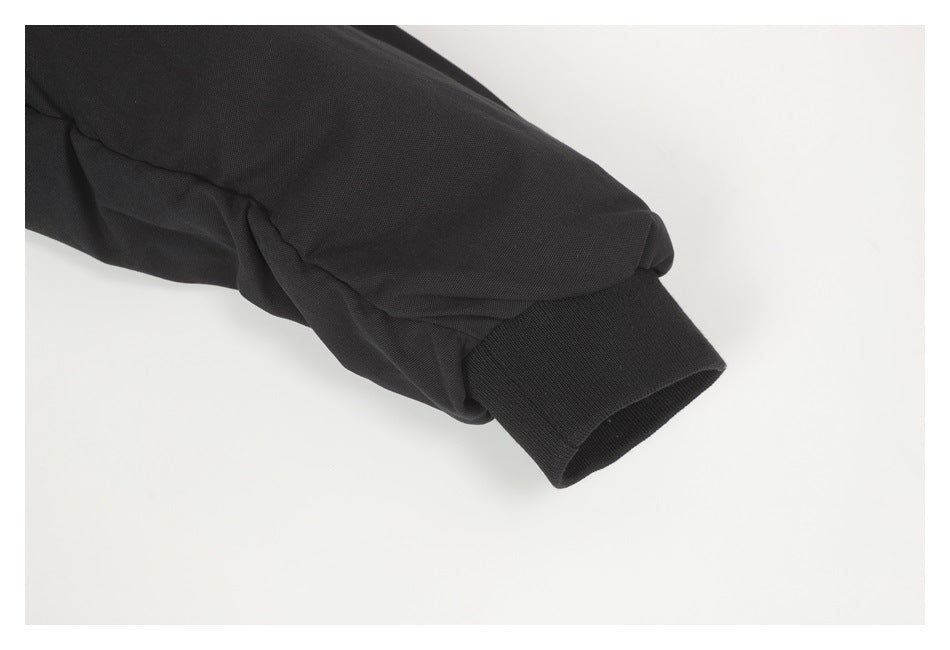 Close-up of a black sleeve ending in a wide ribbed cuff.