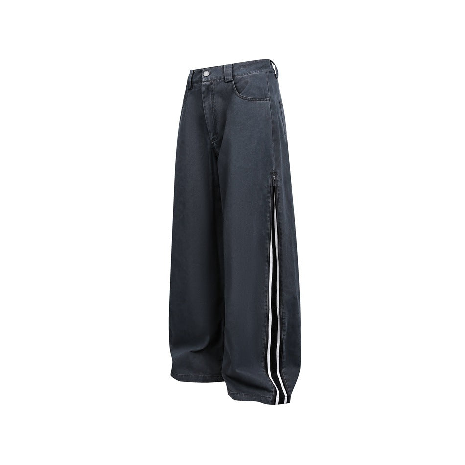 Washed black-gray wide-leg pants with side zip slit and black and white stripe tape on a white background