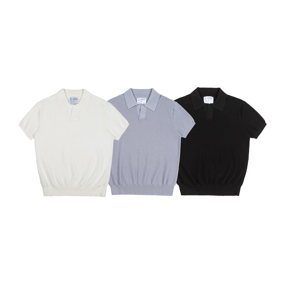 Front view of short-sleeve knit polo shirts in white, pale blue, and black.