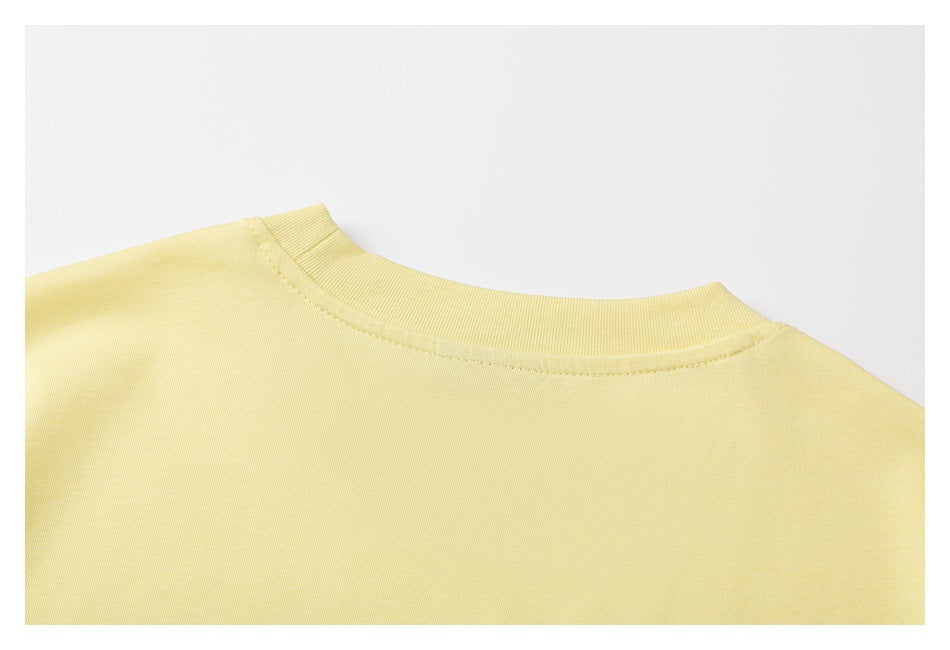 Close-up of the plain back neckline of a pale yellow T-shirt with ribbed collar.