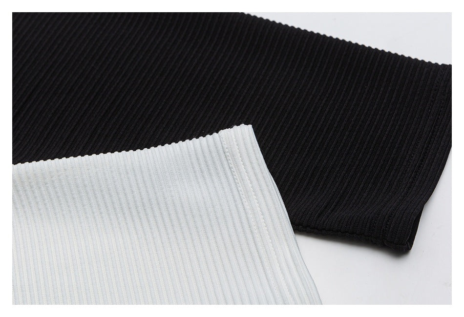 Close-up of black and white ribbed shirt fabric and finished edges.