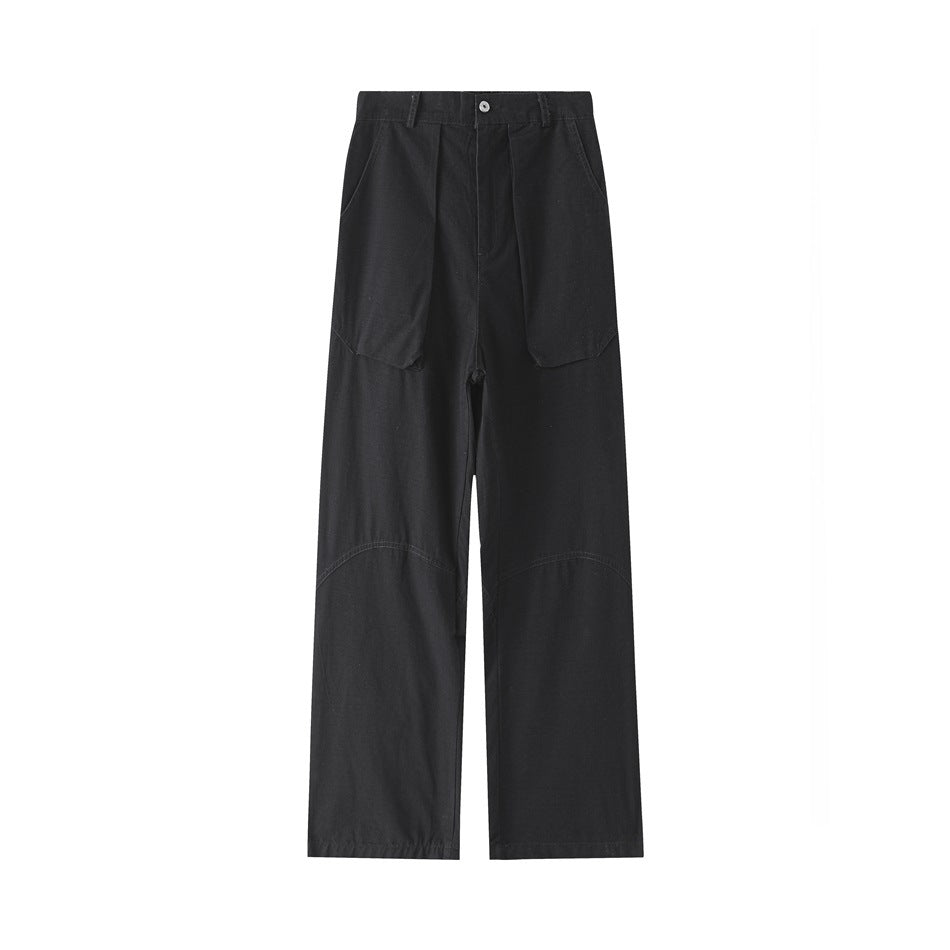 Black wide straight-leg pants flat lay, front view with large flap pockets and curved knee seams
