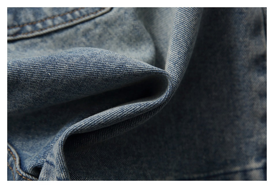 Macro view of the blue denim weave and folded fabric.