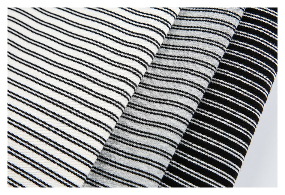 Close-up of horizontal black stripes on white, gray, and black shirt fabric colorways.