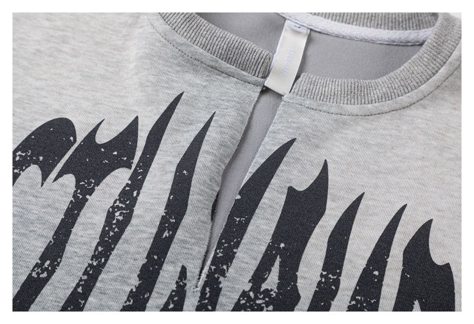 Close-up of a ribbed crew neckline and inner tag on a heather-gray garment with partial black print.