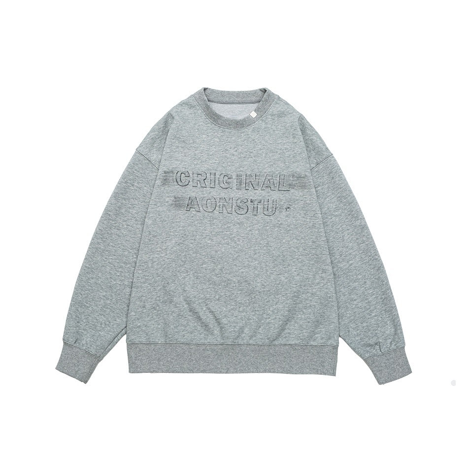 Heather gray crewneck sweatshirt flat lay with embossed CRIGINAL AONSTU lettering, ribbed cuffs and hem