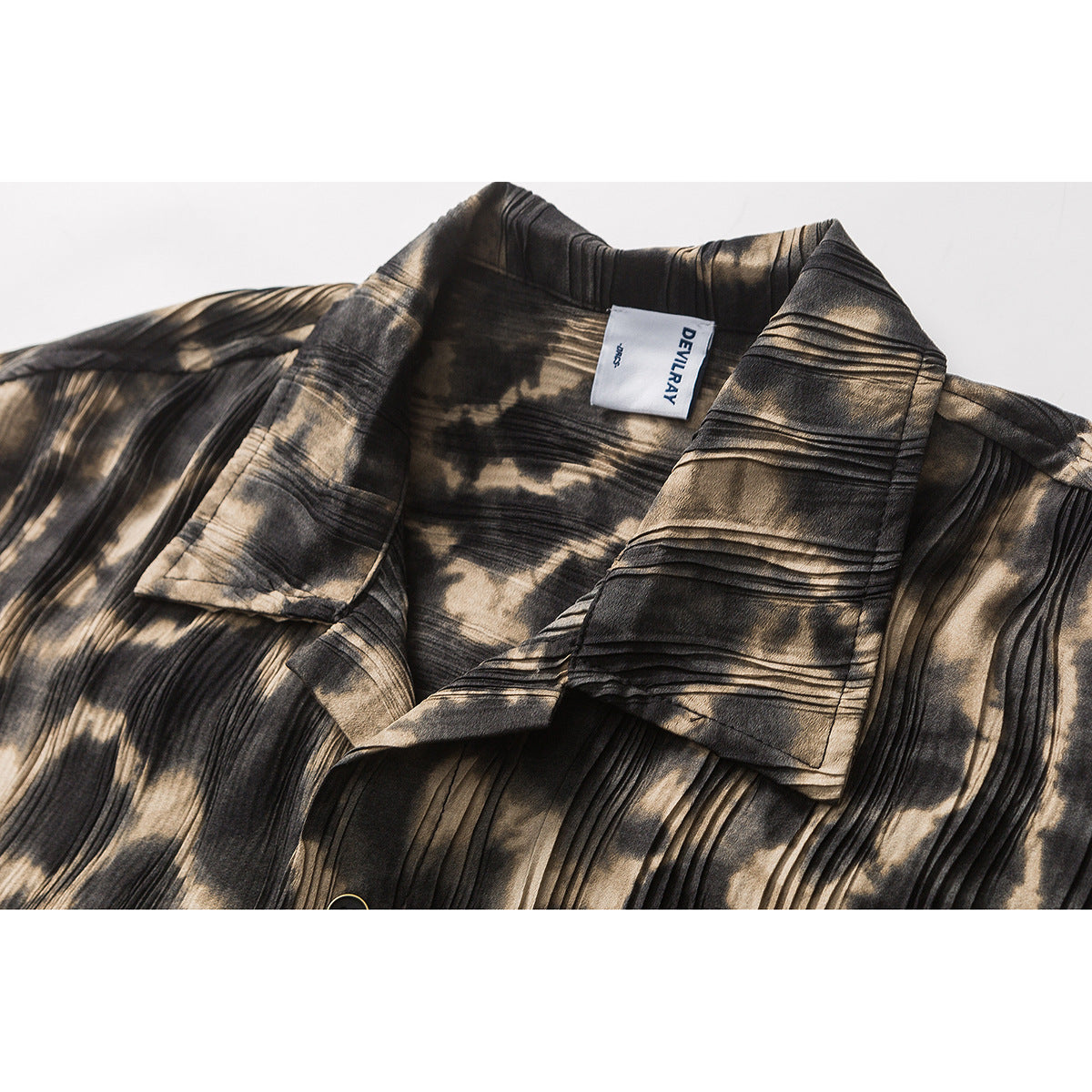 Close-up of a black and tan patterned shirt collar with a sewn-in neck label.