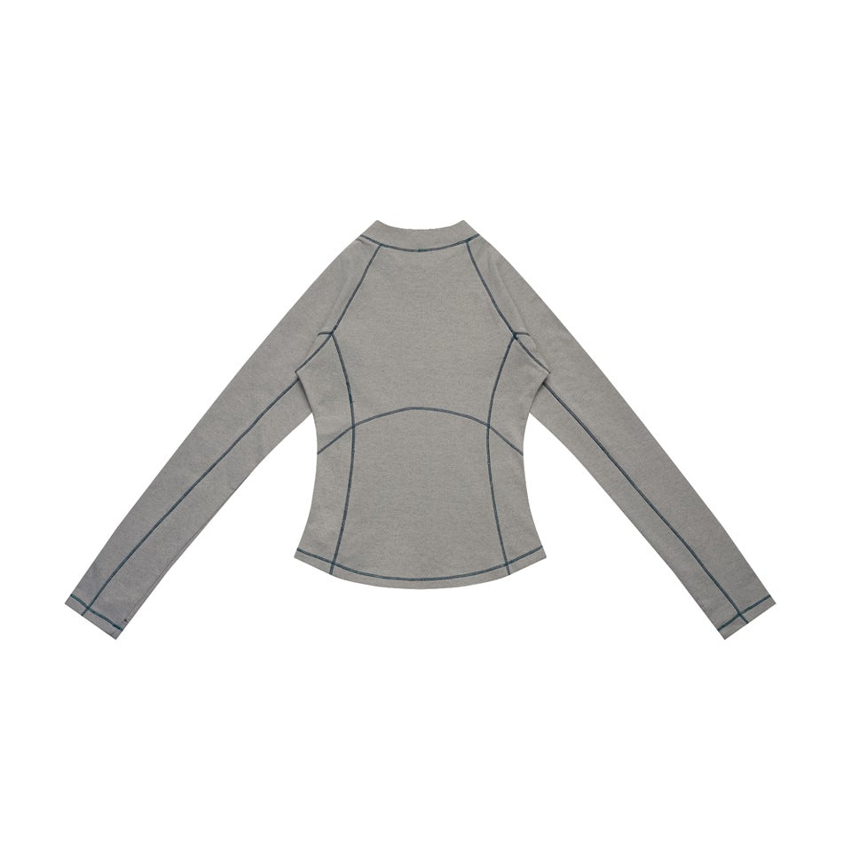 Back view of a gray long-sleeve top with dark contrast seam stitching, laid flat.