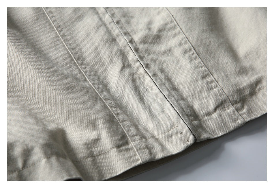 Close-up of the off-white jacket hem with stitched panel seams.
