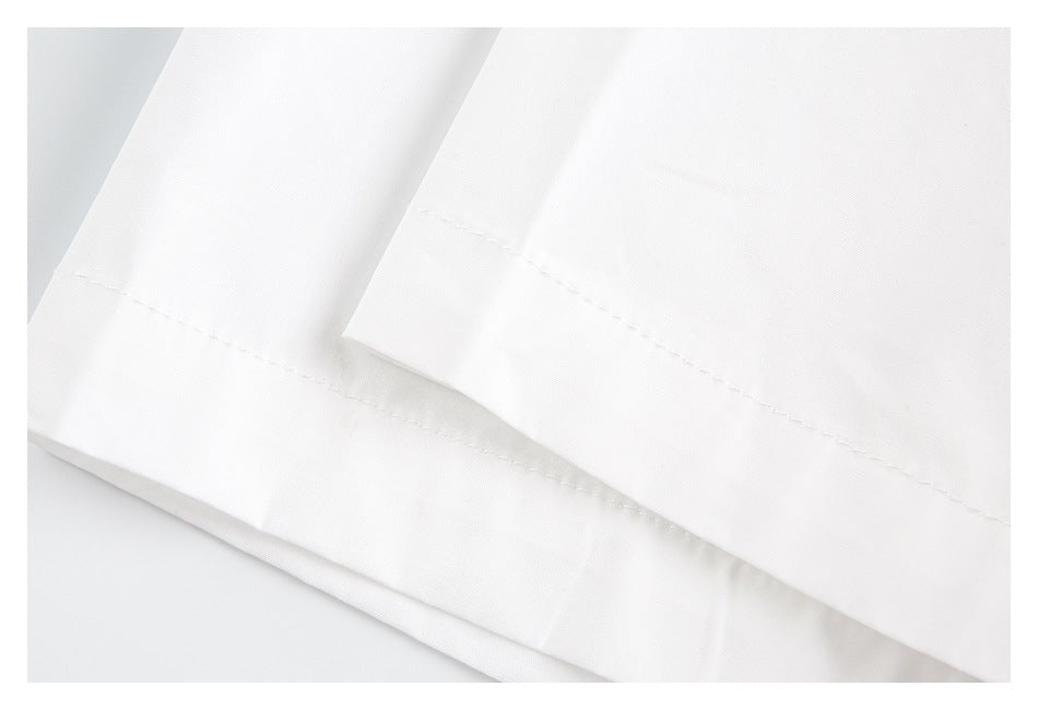 Close-up of a white garment hem with parallel rows of stitching and overlapping fabric.