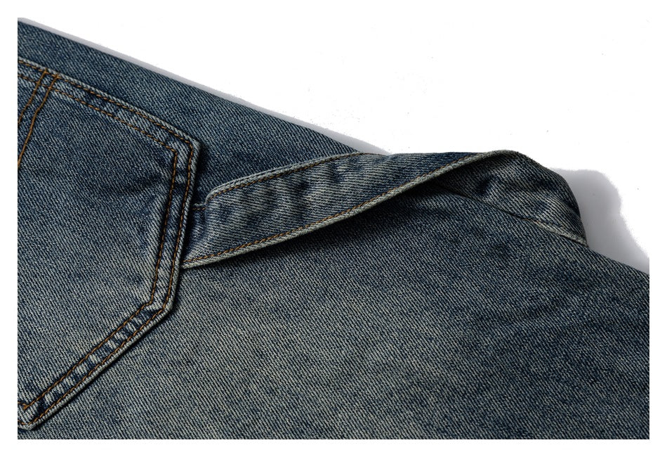 Close-up of the back pocket edge and overlapping seams on blue jeans.