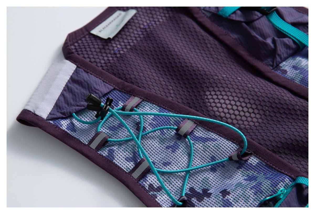 Close-up of turquoise elastic cord lacing across a patterned mesh panel beside purple mesh on the vest.