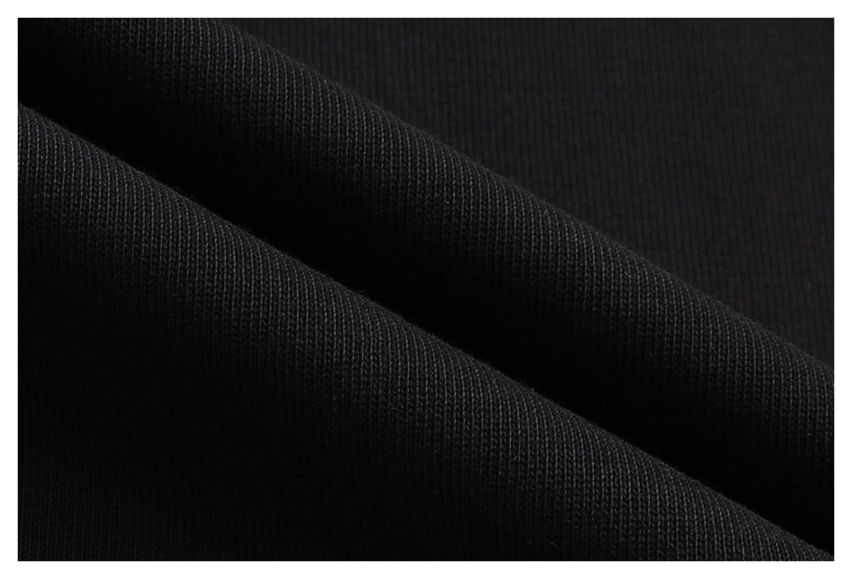 Macro view of black fabric folded to show its knit texture.