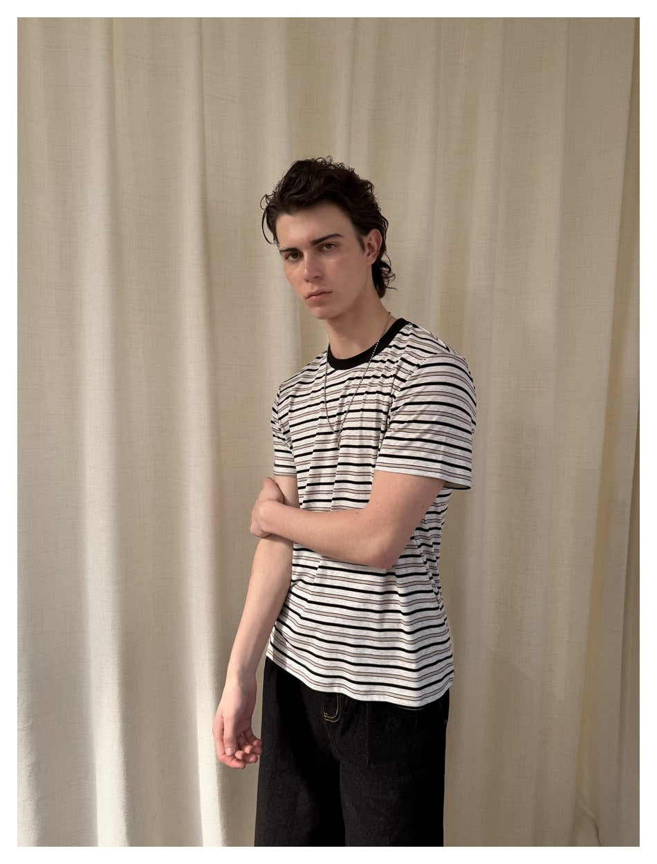Model wearing a light gray and black horizontally striped short-sleeve T-shirt, shown at a three-quarter angle.