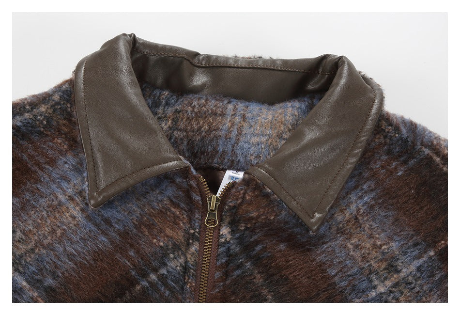Close-up of the jacket’s brown pointed collar and brass front zipper against brown-and-blue plaid fabric.