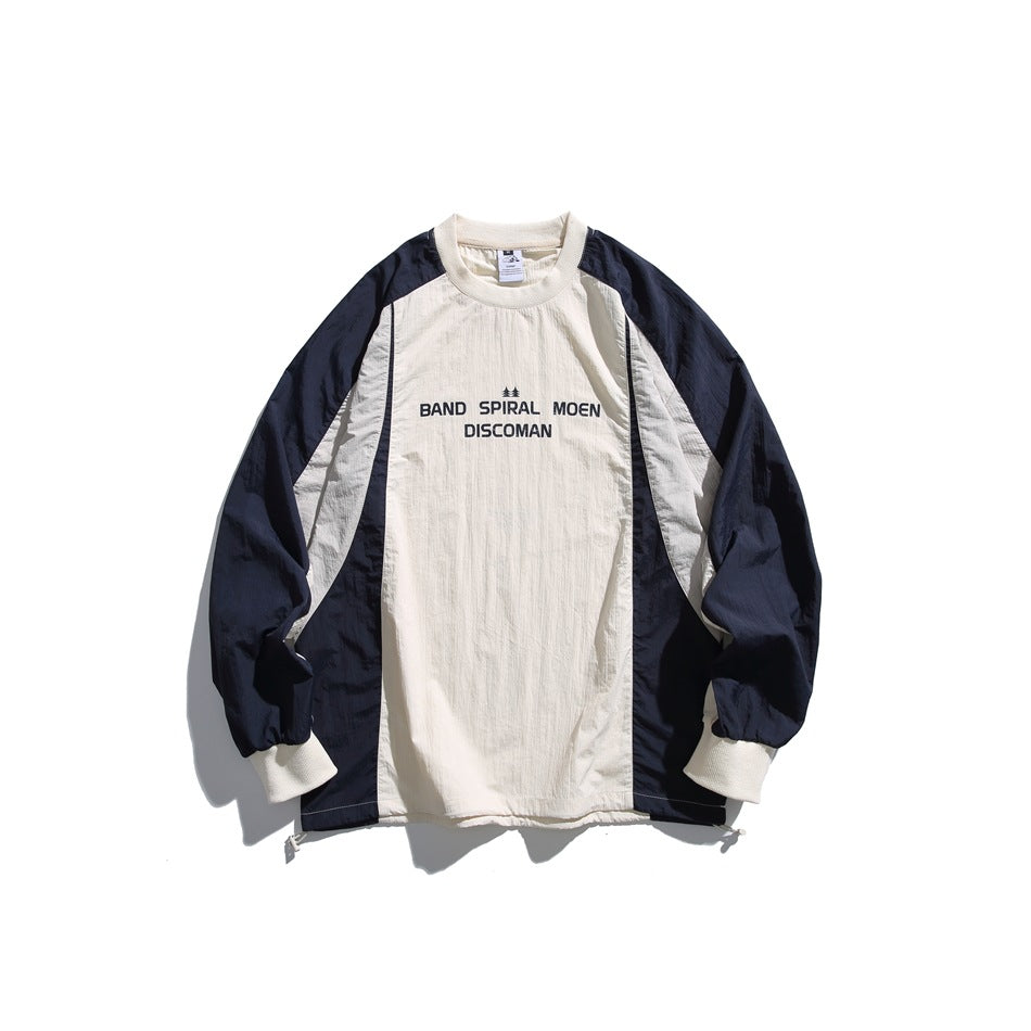 Cream and navy color-block crew-neck sweatshirt flat lay with black chest print and ribbed cuffs