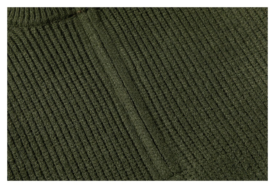Close-up of the olive sweater's textured vertical rib knit.