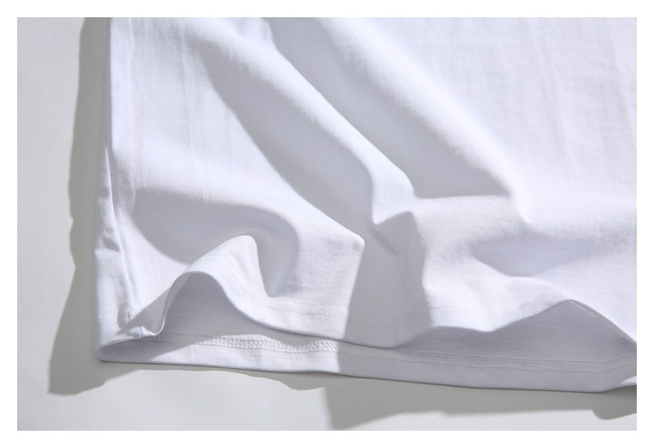 Close-up of the white shirt's stitched hem and fabric folds.