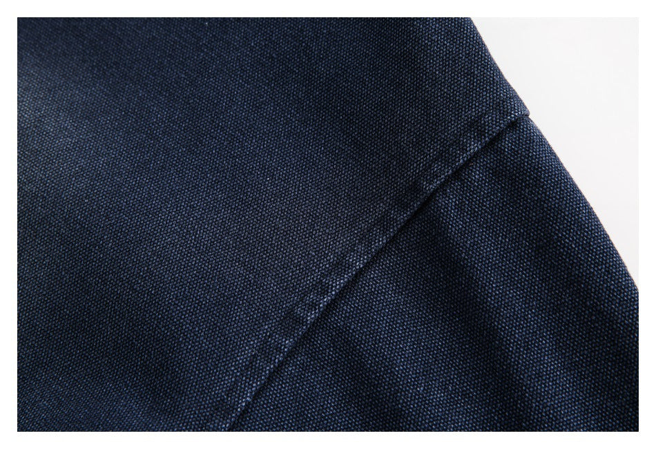 Close-up of a diagonal seam on the textured navy garment.