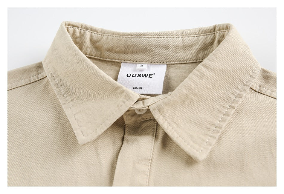 Close-up of a beige shirt collar, button placket, and sewn-in OUSWE label.