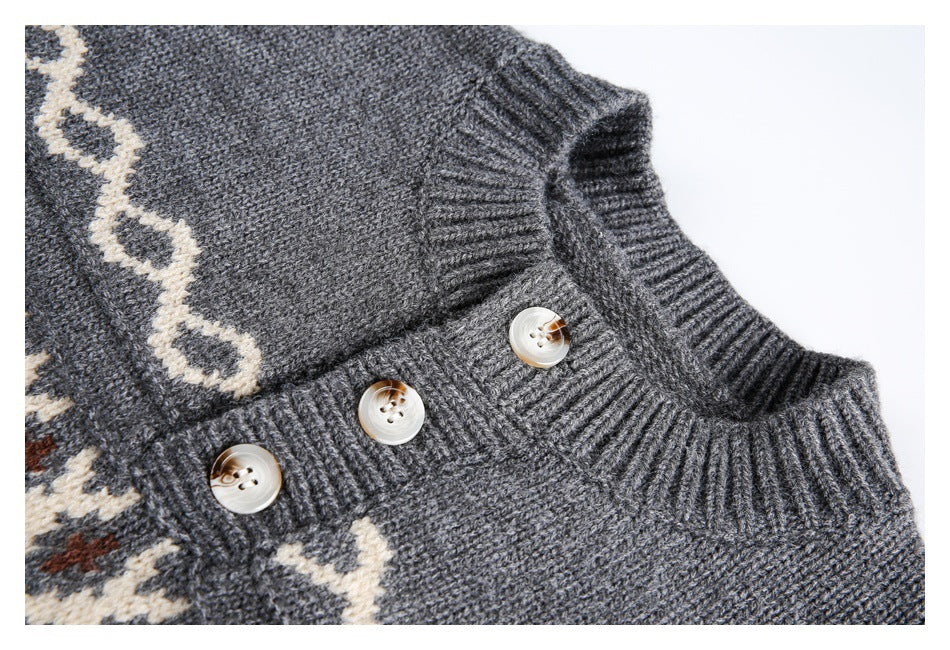 Close-up of a charcoal sweater’s ribbed neckline and three-button placket with cream patterned trim.