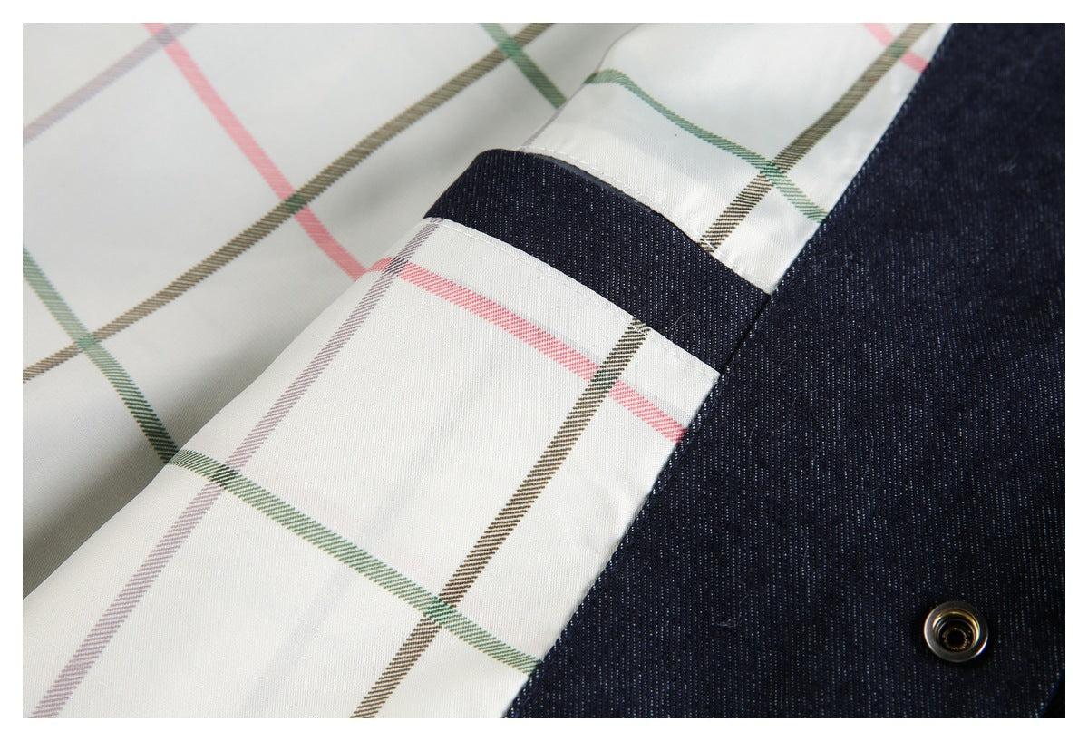 Close-up of cream plaid lining beside dark indigo fabric and a metal snap.