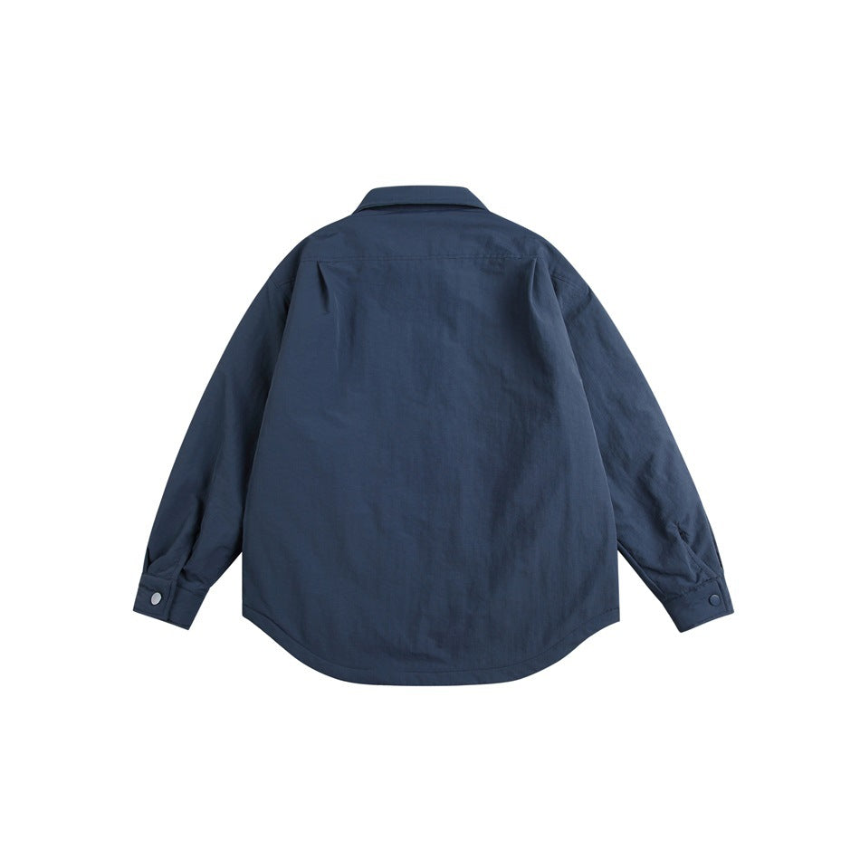 Back view of a navy button-front jacket with long sleeves, button cuffs and a curved hem.