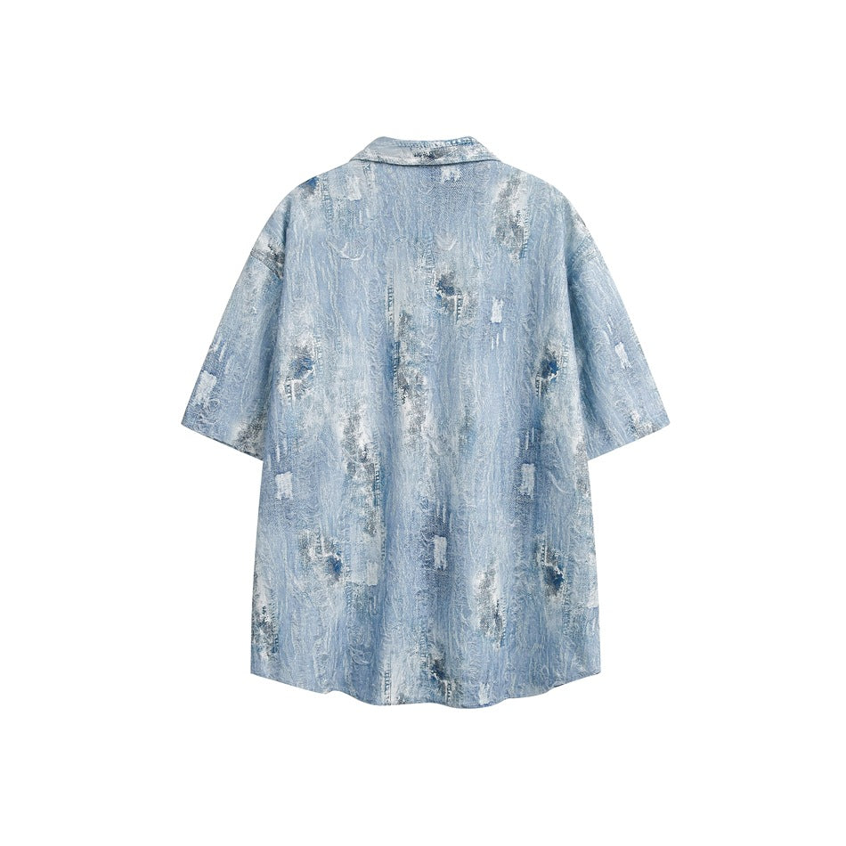 Back view of a light blue short-sleeve button-up shirt with an allover distressed pattern.