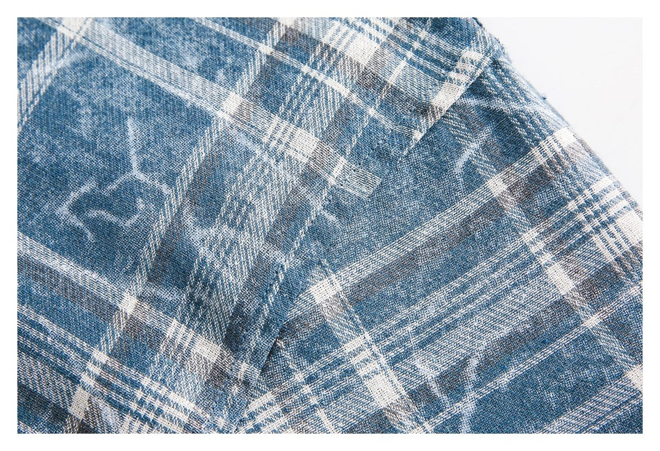 Close-up showing the blue-and-white plaid pattern and stitching on the shirt.